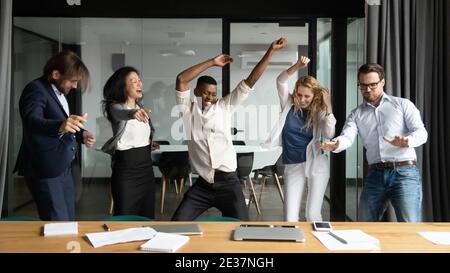 Persone di affari multirazziali emotive pazzi che si divertono in ufficio. Foto Stock