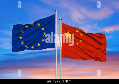 EU and Chinese flags against of blue sky Stock Photo