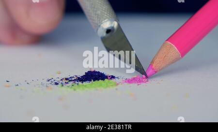 Immagine closeup con una mano di una persona affilatura di una matita colorata Foto Stock