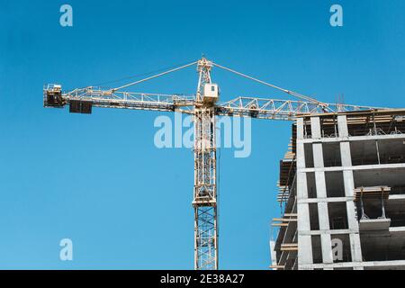 Profilati in acciaio di un edificio in costruzione, con gru a torre Foto Stock