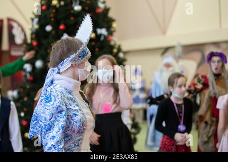 24 dicembre 2020. Bielorussia, la città di Gomil. Vacanze di Natale in città durante l'epidemia di coronavirus. Russo Snow Maiden in una maschera medica a. Foto Stock