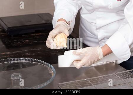 Estrazione di cupcakes da muffa bianca in silicone. Primo piano. Foto Stock