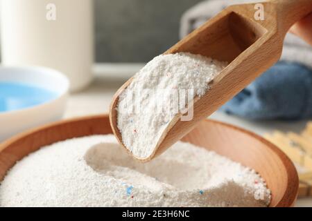 Ciotola di legno e paletta con polvere di bucato, primo piano Foto Stock