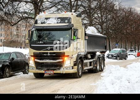 Il cassone ribaltabile Volvo FM toglie la neve dalle strade a un sito di discarica della neve in città. Helsinki, Finlandia. 18 gennaio 2021. Foto Stock