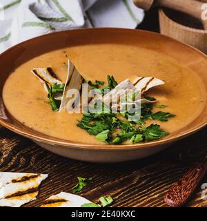 Ciotola di zuppa di verdure, pane pita, sano pasto vegano su rustico tavolo di legno Foto Stock
