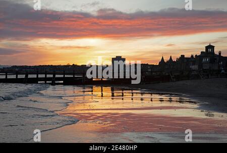 Portobello, Edimburgo, Scozia. 22 gennaio 2021. UK Cool Sunrise al mare con una temperatura di 2 gradi centigradi e un vento bitingly freddo per renderlo più fresco dal Firth of Forth. Le nuvole del mattino presto si riflettevano nella sabbia bagnata. Credit: Arch White/Alamy Live News. Foto Stock