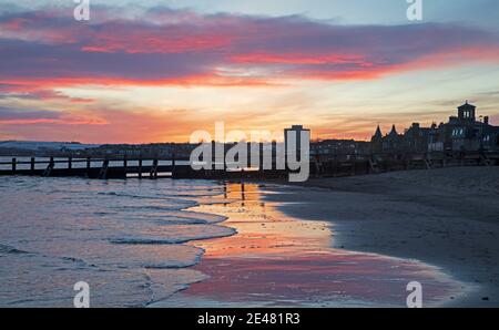 Portobello, Edimburgo, Scozia. 22 gennaio 2021. UK Cool Sunrise al mare con una temperatura di 2 gradi centigradi e un vento bitingly freddo per renderlo più fresco dal Firth of Forth. Le nuvole del mattino presto si riflettevano nella sabbia bagnata. Credit: Arch White/Alamy Live News. Foto Stock