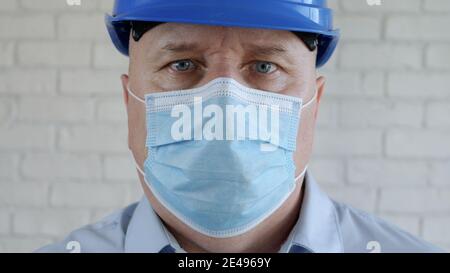 Immagine sicura con un ingegnere che indossa una maschera di protezione del viso contro i virus. Foto Stock