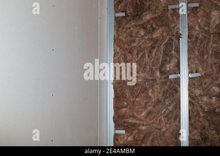 Isolamento e isolamento acustico delle pareti con lana minerale, prima della facciata con cartongesso. Ristrutturazione della casa,. Foto Stock
