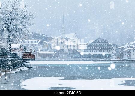 Italia, Veneto, provincia di Belluno, Agordino, Dolomiti, il villaggio di Alleghe sul lago sotto una nevicata Foto Stock