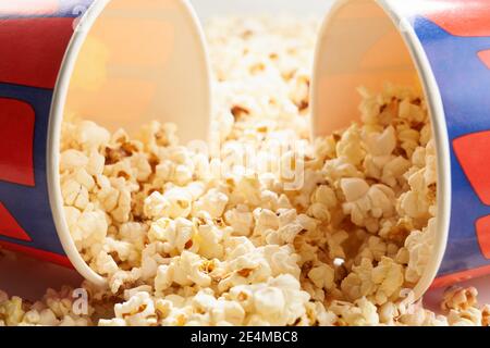 Popcorn sparso da due secchi di carta. Concetto di cinema. Foto Stock