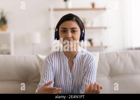 Ritratto di fidata donna indiana esperto in cuffie aiutare il cliente Foto Stock