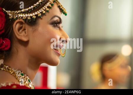 Sposa indiana durante la sessione di trucco Foto Stock