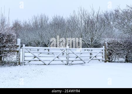 Neve che copre un cancello di legno Foto Stock