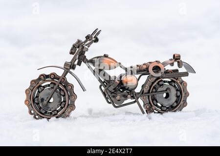 Il modello in metallo di bronzo di una motocicletta sportiva si trova su un sfondo bianco Foto Stock