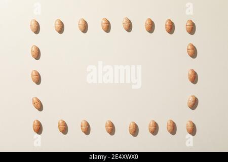 Quadrato fatto di pillole su uno sfondo grigio, un concetto creativo di medicina e pillole geometriche Foto Stock
