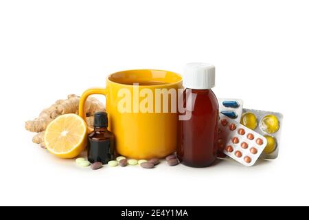 Tazza di tè e diversi medicinali isolati su bianco, un concetto di trattamento domestico per il raffreddore e l'influenza Foto Stock