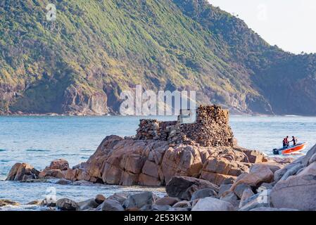 Con il monte Yacaaba sullo sfondo, i resti di una guerra mondiale due armi di collocazione prendere la luce del mattino all'ingresso di Port Stephens Foto Stock