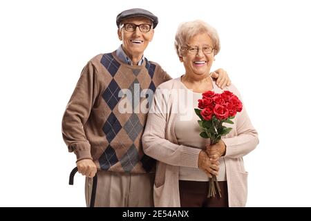 Coppia anziana in piedi con rose rosse isolate su sfondo bianco Foto Stock