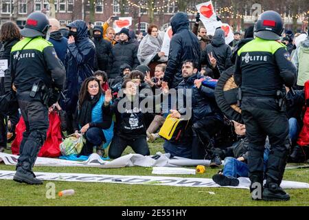 AMSTERDAM, PAESI BASSI, 24 GENNAIO: I manifestanti si scontrano con la polizia antisommossa nei pressi del Museumplein il 24 gennaio 2021 ad Amsterdam, Paesi Bassi. Foto Stock