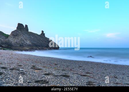 Splendida vista a terra bassa e lunga esposizione delle rovine del castello nero e del mare, South Quay, Corporation Lands, Co. Wicklow, Irlanda. Linea costiera di Wicklow Foto Stock