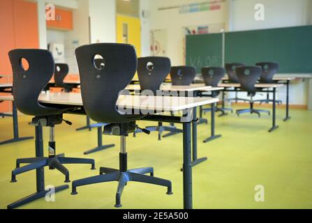 Oranienburg, Germania. 21 Gennaio 2021. Le sedie sono collocate sulle panchine della scuola in un'aula vuota della scuola Comenius. Cinque anni fa la scuola elementare integrativa con gruppi di sostegno linguistico si era trasferita a Oranienburg-Süd in un nuovo edificio. Credit: Soeren Stache/dpa-Zentralbild/ZB/dpa/Alamy Live News Foto Stock