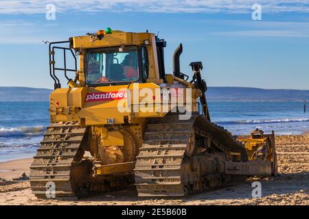 Cat D6T LGP bulldozer crawler caterpillar - programma di rinnovo dei groyne in legno che si svolge sulla spiaggia ad Alum Chine, Bournemouth, Dorset UK a gennaio Foto Stock