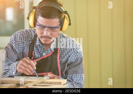 Ritratto di un falegname che lavora in un laboratorio, Thailandia Foto Stock