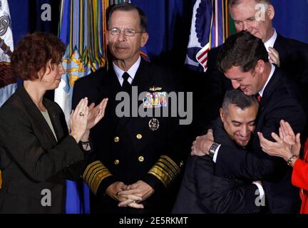 U.S. Rep. Patrick Murphy (D-PA) (R) hugs former U.S. Marine Corps Staff Sgt. Eric Alva (2nd R) as former U.S. Navy Commander Zoe Dunning (L) and Chairman of the Joint Chiefs of Staff Admiral Mike Mullen look on before President Barack Obama signs the Don't Ask, Don't Tell Repeal Act of 2010 lifting the ban on homosexuals serving openly in the U.S. armed forces at the Department of the Interior in Washington, December 22, 2010. REUTERS/Jim Young      (UNITED STATES - Tags: POLITICS MILITARY)