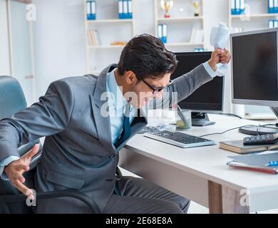 L imprenditore seduto di fronte a molte schermate Foto Stock