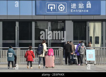 Fuyang, Cina. 29 gennaio 2021. I passeggeri con bagagli entrano nella stazione ferroviaria di Fuyang. Con l'inizio della corsa di primavera del Festival, gli operatori di trasporto hanno stretto misure per prevenire la rinascita dei casi COVID-19 (Coronavirus) rendendo obbligatoria la maschera facciale per tutti i passeggeri della stazione ferroviaria. Secondo il ministero, circa 1.15 miliardi di viaggi di passeggeri avrebbero dovuto essere effettuati durante la corsa di 40 giorni, con un calo annuale del 20% e più del 60% inferiore rispetto al 2019. Credit: SOPA Images Limited/Alamy Live News Foto Stock