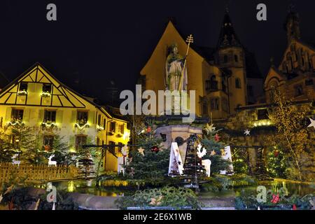 Francia, Haut Rhin, Eguisheim, etichettati Les Plus Beaux Villages de France (i più bei villaggi di Francia), Place du Chateau, Saint Leon fontana, le luci di Natale Foto Stock