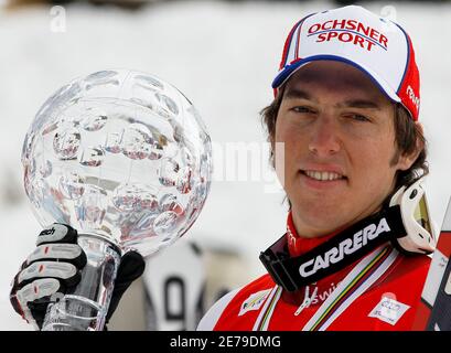 Carlo Janka of Switzerland poses with the men's overall Alpine Skiing World Cup trophy in Garmisch-Partenkirchen March 13, 2010.  REUTERS/Miro Kuzmanovic (GERMANY - Tags: SPORT SKIING)