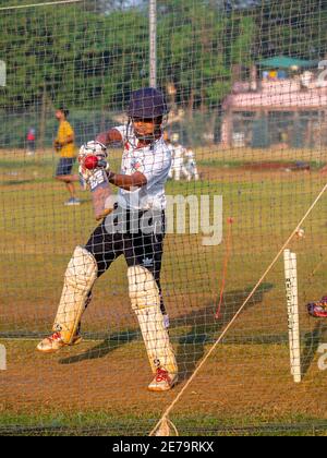 Mumbai, India - 20 dicembre 2020: Ragazzo non identificato che pratica batting per migliorare le abilità di cricketing a Mumbai Ground Foto Stock