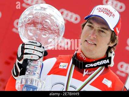 Carlo Janka of Switzerland poses with the men's overall Alpine Skiing World Cup trophy in Garmisch-Partenkirchen March 13, 2010.     REUTERS/Michaela Rehle (GERMANY - Tags: SPORT SKIING)