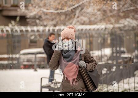 Praga, Repubblica Ceca. 01-29-2021. Ritratto di donna con maschera che cammina nel centro di Praga durante una soleggiata e fredda mattina d'inverno. Foto Stock