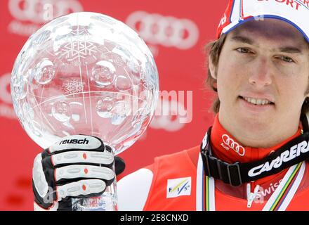 Carlo Janka of Switzerland poses with the men's overall Alpine Skiing World Cup trophy in Garmisch-Partenkirchen March 13, 2010. REUTERS/Michaela Rehle (GERMANY - Tags: SPORT SKIING)
