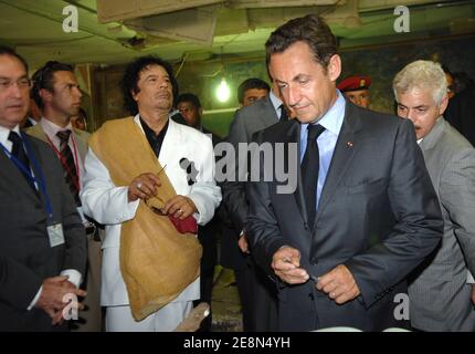 Libya's President Moammar Gadhafi (L) greets his French counterpart Nicolas Sarkozy and Claude Gueant at Bab Azizia Palace in Tripoli, Libya on July 25, 2007. Sarkozy met Gadhafi on Wednesday on a trip to deepen relations after helping to resolve a diplomatic standoff that hurt the oil exporter's ties with the West. Photo by Christophe Guibbaud/ABACAPRESS.COM Stock Photo