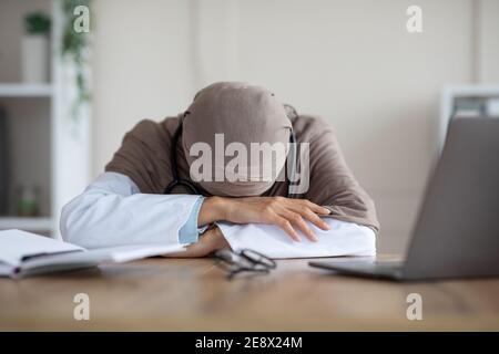 Dottoressa lavorava in eccesso con un sonnellino alla scrivania Foto Stock