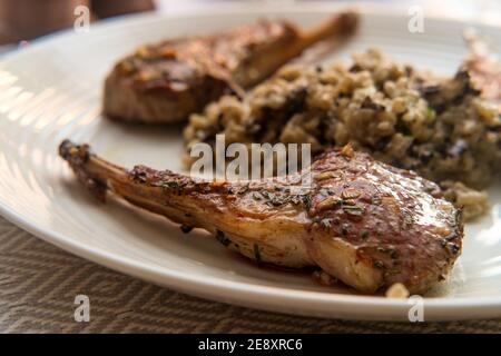 Costoletta di agnello marinata alla griglia con risotto di funghi cheesy Foto Stock