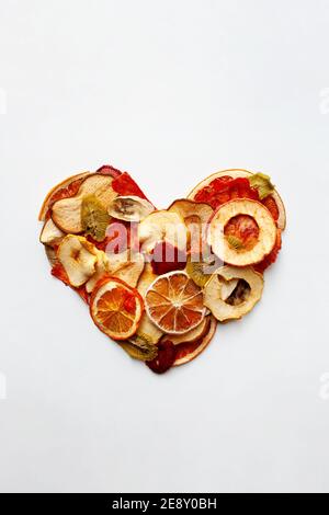 Cuore di frutta secca a fette isolato su sfondo bianco Foto Stock