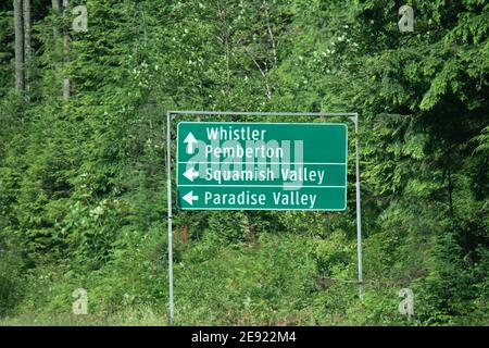 Vista del cartello con le frecce direzionali che puntano a Whistler Pemberton, Squamish Valley e Paradise Valley on Sea to Sky Highway Foto Stock