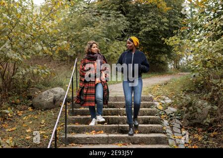 Due giovani donne a camminare nel parco Foto Stock