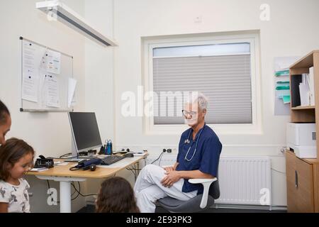 Donna sorridente in ufficio Foto Stock