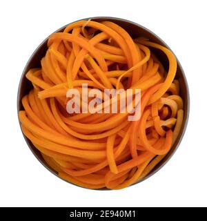 Vista dall'alto di una ciotola di metallo contenente una porzione di tagliatelle di zucca di butternut isolate su uno sfondo bianco. Foto Stock