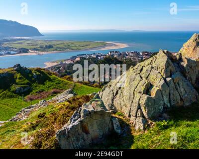View looking down over Deganwy and the mouth of the River Conwy in Conwy North Wales from the ruins of Deganwy Castle with rocks in foreground. Foto Stock