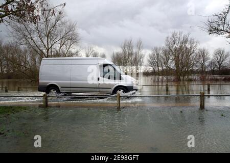 Un pulmino attraversa le acque alluvionali di Laleham-on-Thames, Surrey, dopo lo scoppio delle rive del Tamigi. Data immagine: Mercoledì 3 febbraio 2021. Foto Stock