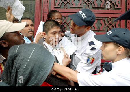 Centinaia di residenti illegali in Francia (soprattutto asiatici e africani) si sono accodati presso il centro di polizia degli stranieri, Rue Truffaut, a Parigi, Francia, il 28 giugno 2006, per chiedere la regolarizzazione dopo il ministro degli interni francese Nicolas Sarkozy, Ha annunciato che la Francia concederà permessi di soggiorno ad alcuni migranti illegali i cui figli frequentano la scuola. Foto di Alain Apaydin/ABACAPRESS.COM Foto Stock