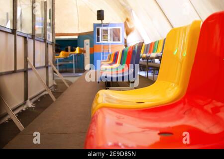 Sedili multicolore. Pista di pattinaggio interna. Stadio sportivo, è sinonimo di tifosi. Foto Stock