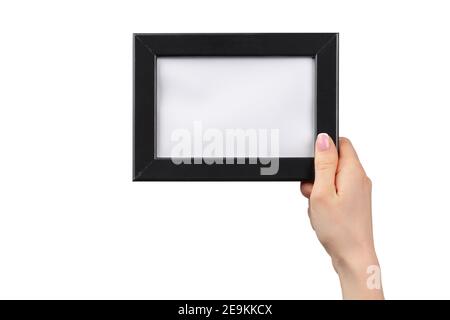 Le mani femminili tengono la cornice fotografica isolata su bianco Foto Stock
